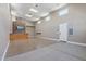 Large bonus room with bar, TV, and storage lift; featuring natural light and easy access to the garage at 18319 W Marshall Ave, Litchfield Park, AZ 85340
