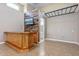 Large bonus room featuring a bar with wood accents, a TV, and a bathroom nearby at 18319 W Marshall Ave, Litchfield Park, AZ 85340