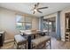 Bright dining area with rustic wooden table, comfortable bench seating, and views of the backyard patio at 18319 W Marshall Ave, Litchfield Park, AZ 85340