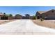 Long driveway leading to a gated backyard providing ample parking and privacy for a well-maintained property at 18319 W Marshall Ave, Litchfield Park, AZ 85340