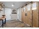 Welcoming entryway featuring stylish barn doors, wood-look floors, and modern decor creating a warm first impression at 18319 W Marshall Ave, Litchfield Park, AZ 85340