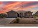 Charming single-story home showcasing desert landscaping, a spacious driveway, and a welcoming facade with a prominent American flag at 18319 W Marshall Ave, Litchfield Park, AZ 85340