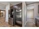 A chef's kitchen is complete with stainless steel appliances and access to a pantry and adjacent rooms at 18319 W Marshall Ave, Litchfield Park, AZ 85340
