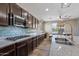 Stylish kitchen with stainless steel appliances, granite countertops, a gas cooktop, and an eat-in dining space at 18319 W Marshall Ave, Litchfield Park, AZ 85340