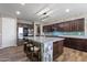 Spacious kitchen featuring granite countertops, stainless steel appliances, and an island with bar seating and stylish lighting at 18319 W Marshall Ave, Litchfield Park, AZ 85340