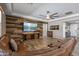 Warm Gathering room featuring a reclaimed wood accent wall, and a cozy leather sectional at 18319 W Marshall Ave, Litchfield Park, AZ 85340