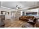 Spacious living room with wood floors, ceiling fan and view into the gourmet kitchen at 18319 W Marshall Ave, Litchfield Park, AZ 85340