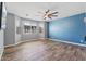 Bright living room featuring wood floors, large windows, and a ceiling fan at 18319 W Marshall Ave, Litchfield Park, AZ 85340