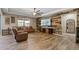 Cozy living room with a wood-accent wall, comfortable leather seating, and modern entertainment setup for relaxation at 18319 W Marshall Ave, Litchfield Park, AZ 85340