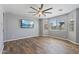 Spacious living room with wood floors, large windows and a ceiling fan at 18319 W Marshall Ave, Litchfield Park, AZ 85340