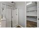 Bright glass shower with bench and adjacent walk-in closet at 18319 W Marshall Ave, Litchfield Park, AZ 85340