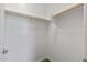 Bright walk-in closet featuring ample storage with white walls and wooden rods at 18319 W Marshall Ave, Litchfield Park, AZ 85340