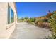 Lush backyard showcasing a serene rock water feature and blooming plants at 189 N Rainbow Way, Casa Grande, AZ 85194
