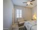 Bright bedroom with a ceiling fan and cozy seating area at 189 N Rainbow Way, Casa Grande, AZ 85194