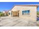 Large concrete patio wraps around back of home; covered patio has seating area and ceiling fan at 189 N Rainbow Way, Casa Grande, AZ 85194