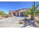 Charming single-story home featuring a three-car garage and desert landscaping at 189 N Rainbow Way, Casa Grande, AZ 85194