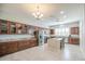 Well-lit kitchen featuring ample counter space, a center island, and stainless steel appliances at 189 N Rainbow Way, Casa Grande, AZ 85194