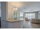 Open-concept living area featuring tile flooring, neutral walls, and plenty of windows with plantation shutters at 189 N Rainbow Way, Casa Grande, AZ 85194