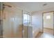 A well-lit bathroom featuring a walk-in shower and a soaking tub by a window at 19321 N Tara Lane Ln, Maricopa, AZ 85138
