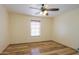 Bedroom with wood floors, a ceiling fan, and a window with blinds at 19321 N Tara Lane Ln, Maricopa, AZ 85138
