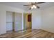Bedroom with wood floors, a ceiling fan, and an closet at 19321 N Tara Lane Ln, Maricopa, AZ 85138