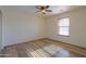 This bedroom offers light-colored walls, wood-look floors and a ceiling fan at 19321 N Tara Lane Ln, Maricopa, AZ 85138