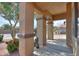 A view of the covered porch with decorative columns and landscaped garden at 19321 N Tara Lane Ln, Maricopa, AZ 85138