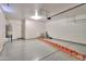 A spacious two car garage with epoxy flooring and a water heater in the corner at 19321 N Tara Lane Ln, Maricopa, AZ 85138