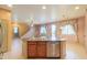Kitchen island with sink, dishwasher, and stairs nearby, leading to the second floor at 19321 N Tara Lane Ln, Maricopa, AZ 85138