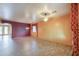 Spacious living room with tile flooring, ceiling fans, and large windows with decorative curtains at 19321 N Tara Lane Ln, Maricopa, AZ 85138