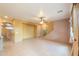 Spacious living room featuring tile flooring, a ceiling fan, and staircase access at 19321 N Tara Lane Ln, Maricopa, AZ 85138