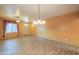 Large living room featuring tile flooring, decorative curtains, a ceiling fan, and a pendant light at 19321 N Tara Lane Ln, Maricopa, AZ 85138