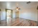 This neutral living room shows multiple openings to other rooms and wood-look floors at 19321 N Tara Lane Ln, Maricopa, AZ 85138