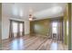 A spacious living room offers wood-look floors and neutral walls at 19321 N Tara Lane Ln, Maricopa, AZ 85138