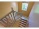 Wooden staircase leading to the upper level with a window at the top at 19321 N Tara Lane Ln, Maricopa, AZ 85138