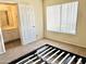 Bedroom featuring neutral carpet, large window, and an en-suite bathroom for convenience and comfort at 19601 N 7Th St Ave # 1036, Phoenix, AZ 85024