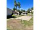 Exterior view of the pool area with palm trees, open lawn and a concrete pad for recreation at 19601 N 7Th St Ave # 1036, Phoenix, AZ 85024