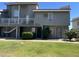 A well-maintained two-story apartment building, showcasing a lawn, balcony, and neatly trimmed bushes at 19601 N 7Th St Ave # 1036, Phoenix, AZ 85024