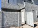 Exterior of a two-story home featuring gray stucco walls, a white front door, and a small enclosed front patio at 19601 N 7Th St Ave # 1036, Phoenix, AZ 85024