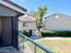 Balcony view of the community featuring manicured green space, colorful flowering bushes and building exteriors at 19601 N 7Th St Ave # 1036, Phoenix, AZ 85024