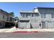 Two-story townhouse exterior with gray stucco, a white privacy wall, and a well-maintained landscape in a community at 19601 N 7Th St Ave # 1036, Phoenix, AZ 85024