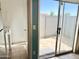 Bright laundry room with tile floors and glass door leading to a private outdoor space at 19601 N 7Th St Ave # 1036, Phoenix, AZ 85024