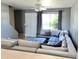 Living room with large sectional sofa and window with curtains at 19601 N 7Th St Ave # 1036, Phoenix, AZ 85024