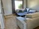 Living room with large sectional sofa, carpet and view into entry at 19601 N 7Th St Ave # 1036, Phoenix, AZ 85024