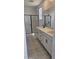 Modern bathroom featuring dual sinks, quartz countertops, black hardware, and a glass-enclosed shower at 20645 N 226Th Ln, Surprise, AZ 85387