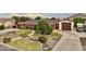 Aerial view of a home showcasing the charming front yard, a bridge, mature trees and a three car garage at 21131 E Excelsior Ave, Queen Creek, AZ 85142