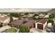 Aerial view of the property highlighting the well-manicured lawn and a three car garage at 21131 E Excelsior Ave, Queen Creek, AZ 85142