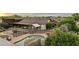 Inviting backyard featuring a pool with rock accents, patio dining, and spa at 21131 E Excelsior Ave, Queen Creek, AZ 85142