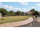 Picturesque backyard showcasing mature trees, lush lawn, and a charming walkway, highlighting the serene outdoor space at 21131 E Excelsior Ave, Queen Creek, AZ 85142