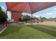 Extensive backyard featuring a covered area and a rock firepit providing lots of outdoor entertainment opportunities at 21131 E Excelsior Ave, Queen Creek, AZ 85142